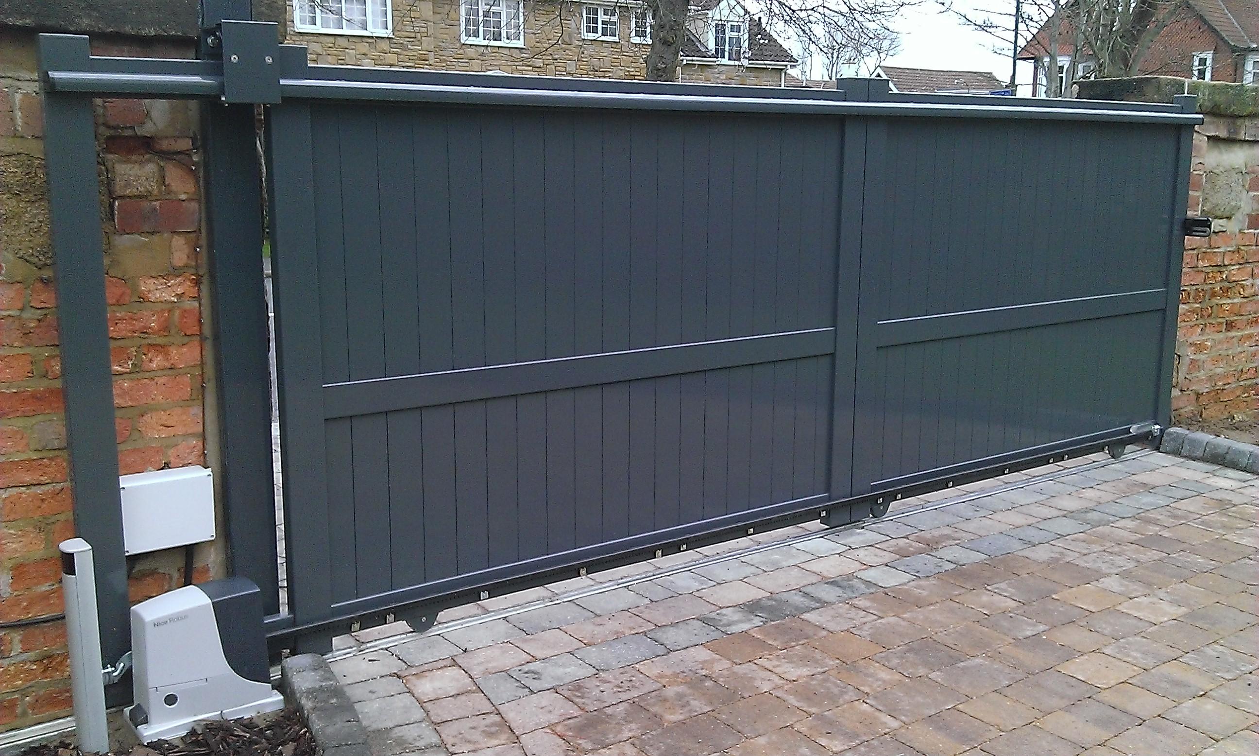 Closed grey sliding gates by Linkcare outside a home